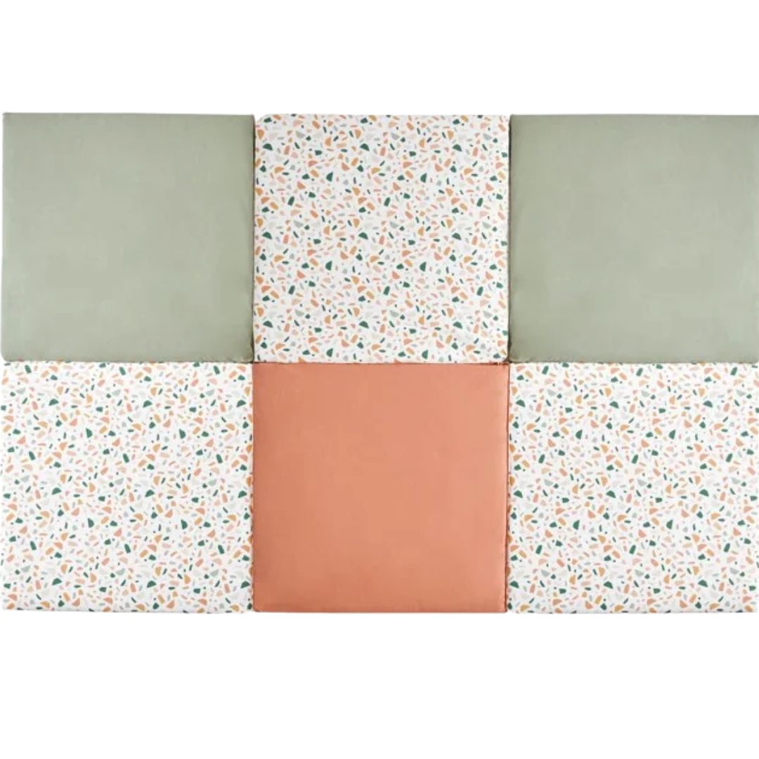 Candide playmat in green, white with small pattern, and terracotta on a white background