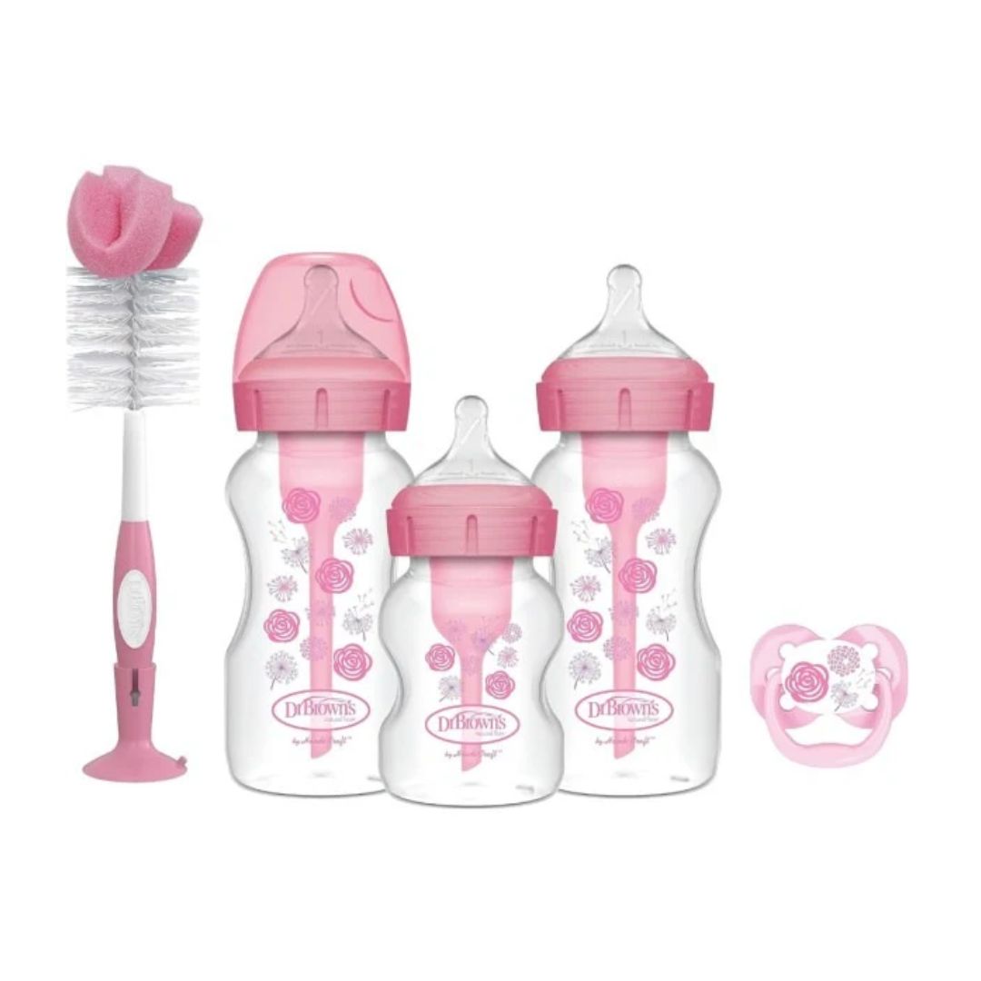 Dr. Brown's Baby bottle set with pink caps and pacifier on a white background