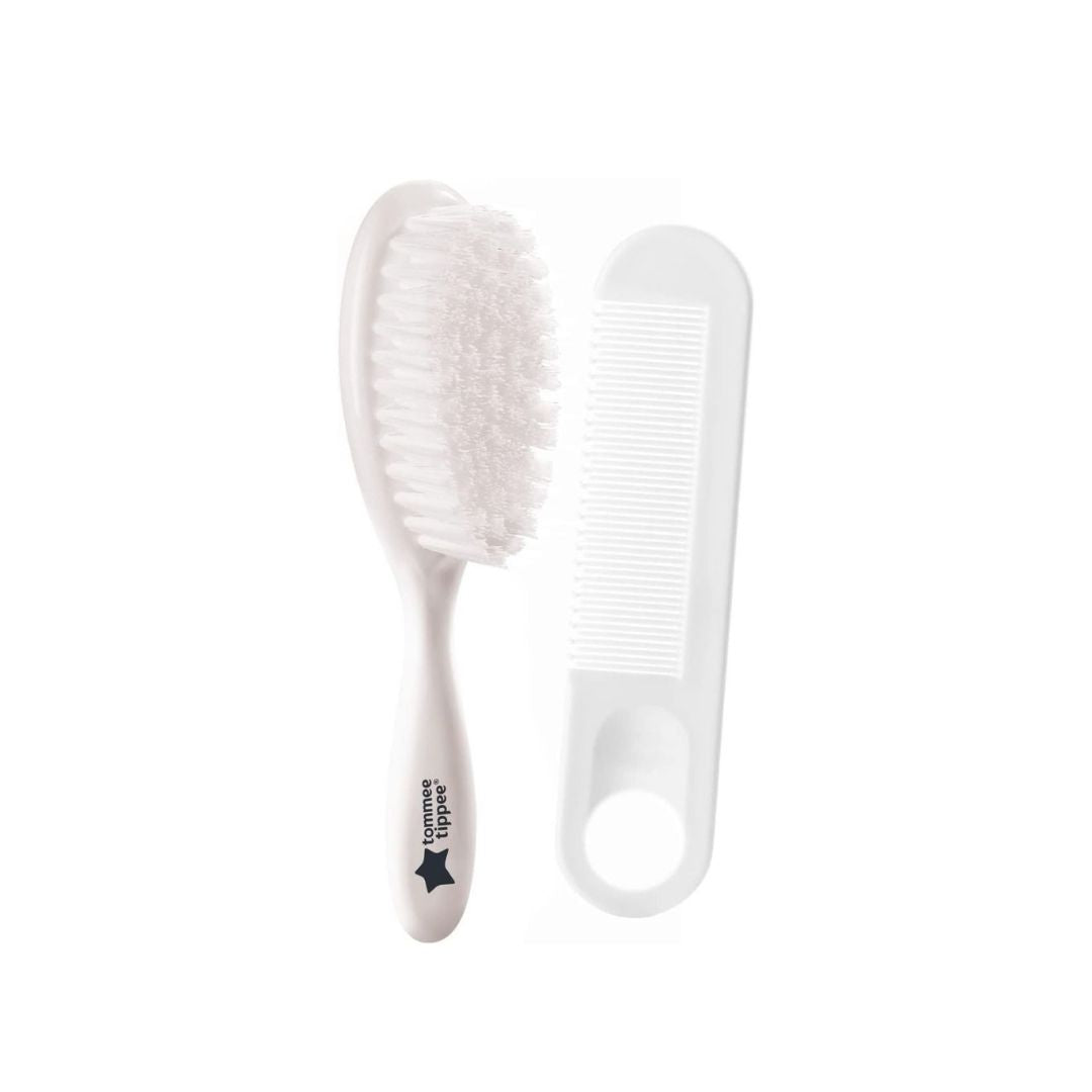 White comb and brush set on a white background