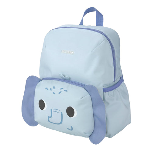 A light blue backpack with a playful elephant face design on the front pocket, featuring floppy ears, large black eyes, and a small blue trunk detail. The brand name 'Skip Hop' is subtly printed on the front upper section.