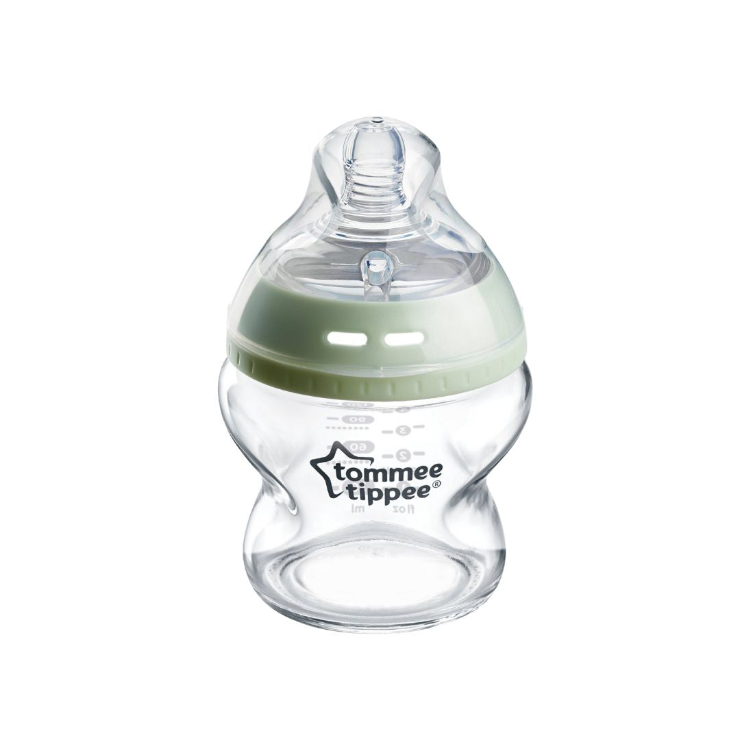 Clear baby bottle with green cap on a white background, featuring Tommee Tippee logo.