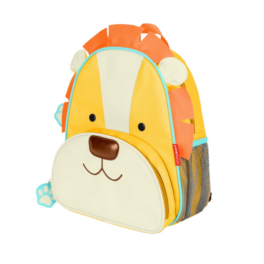 A Skip Hop children's backpack designed like a cartoon lion face, featuring a yellow and cream body, orange mane details, a brown nose, and a mesh side pocket.