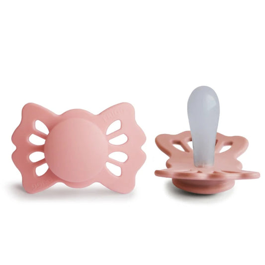 Frigg pink baby pacifiers on a white background