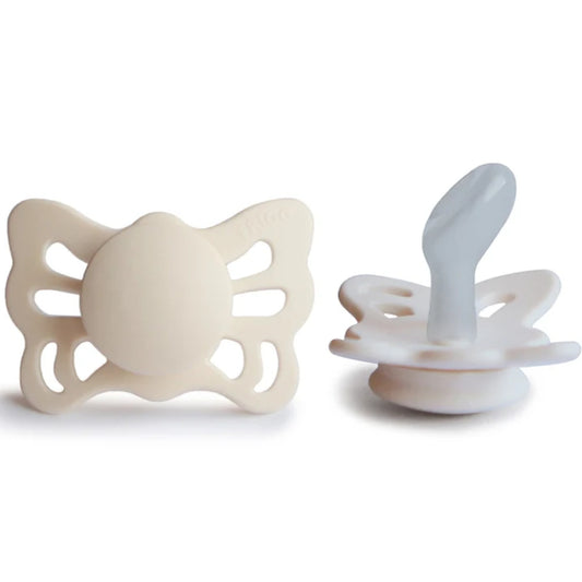Frigg Beige butterfly-shaped pacifiers on a white background