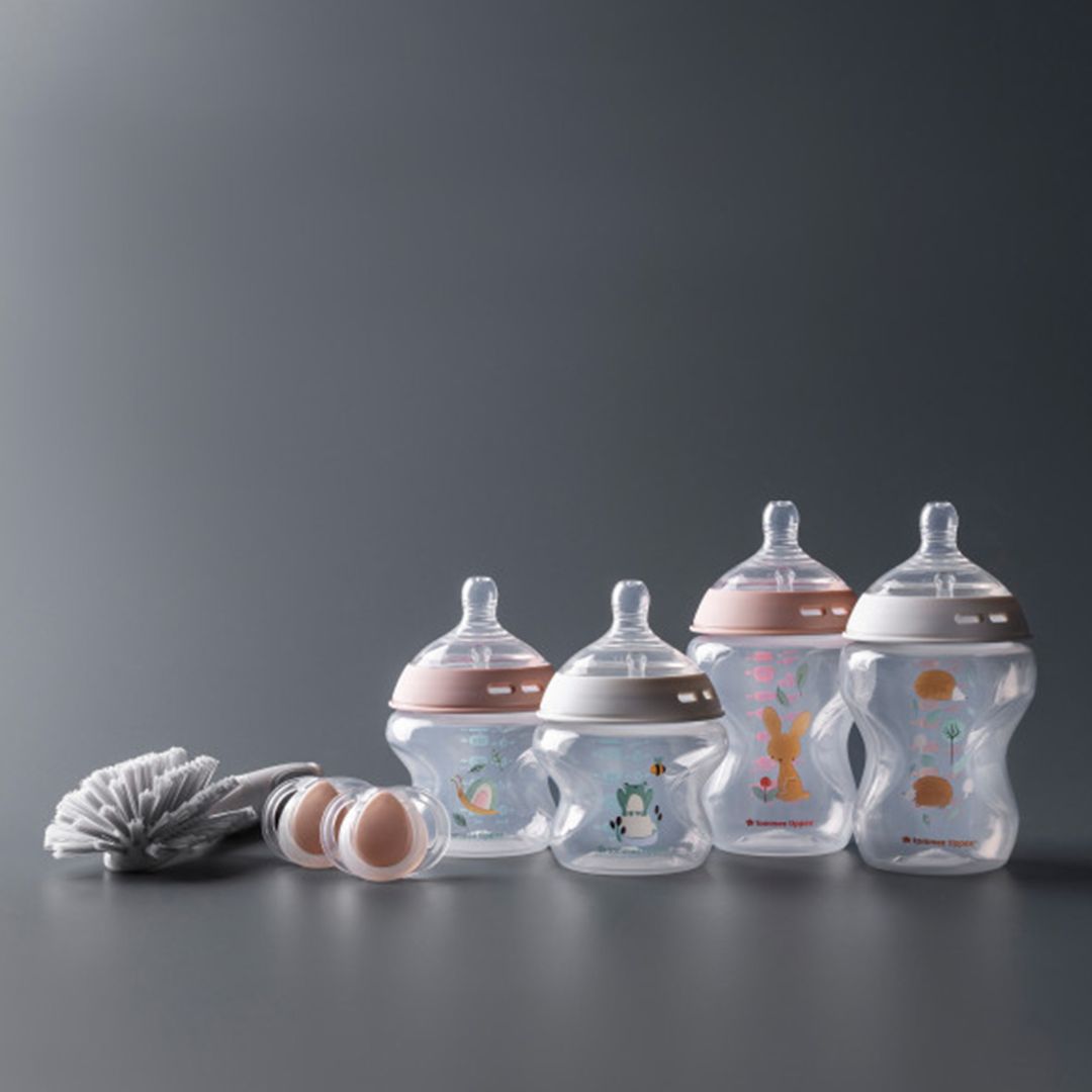 Set of tommee tippee baby bottles with different designs on a dark gray background