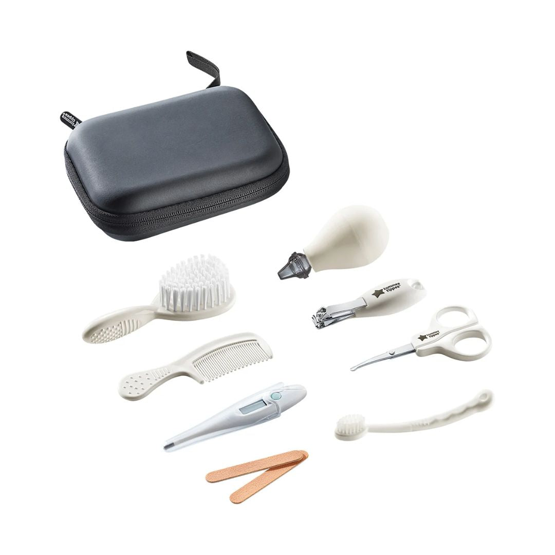 tommee tippee Set of baby grooming tools including a brush, comb, scissors, and others on a white background.