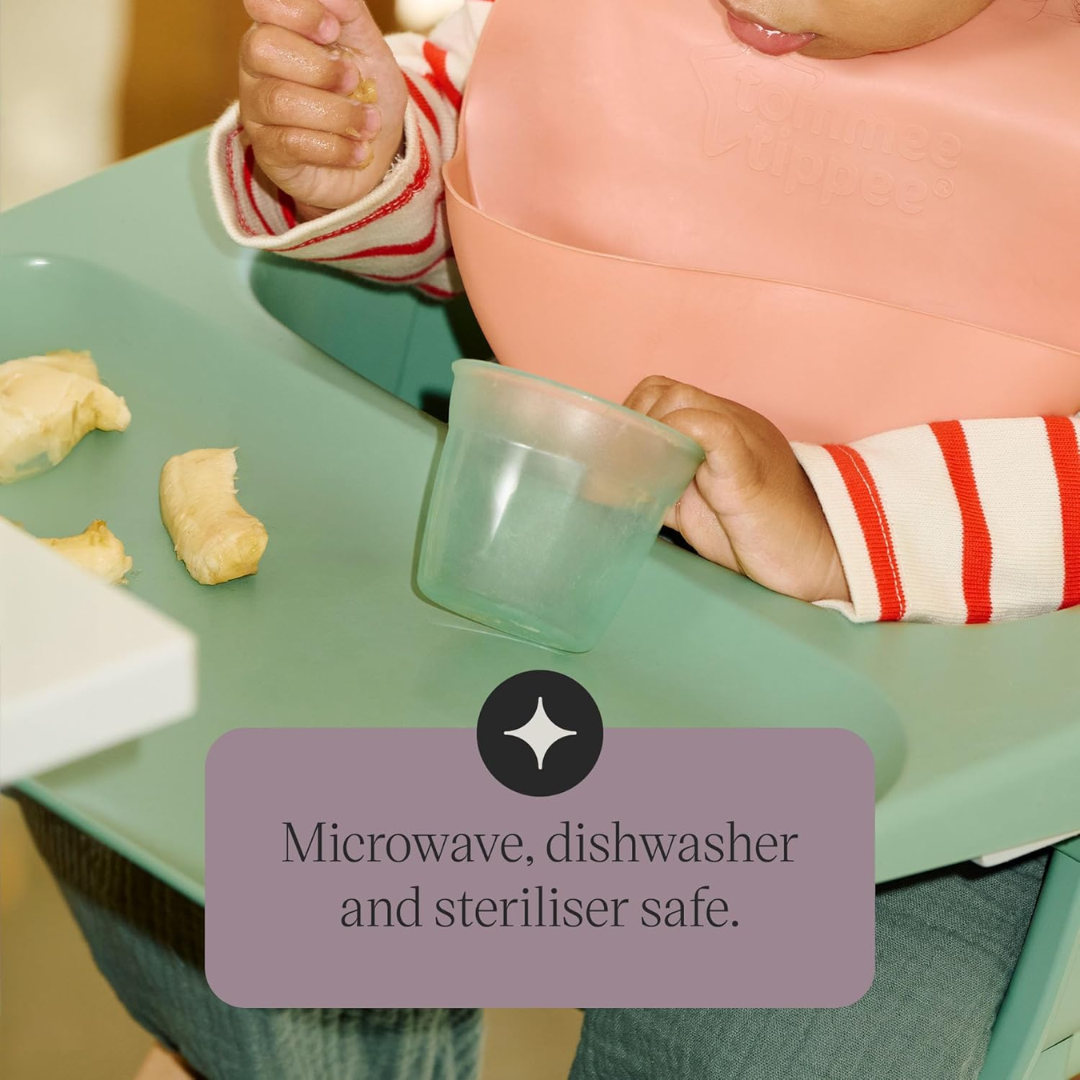 Child in a high chair with a tray of food and a container, with text indicating safety features.
