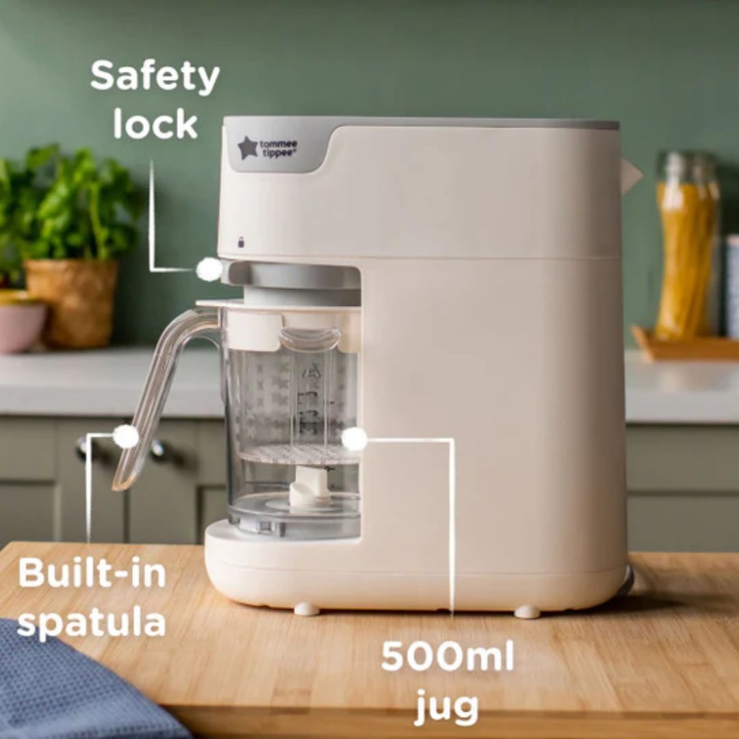 Tommee tippee white food maker on a wooden countertop.
