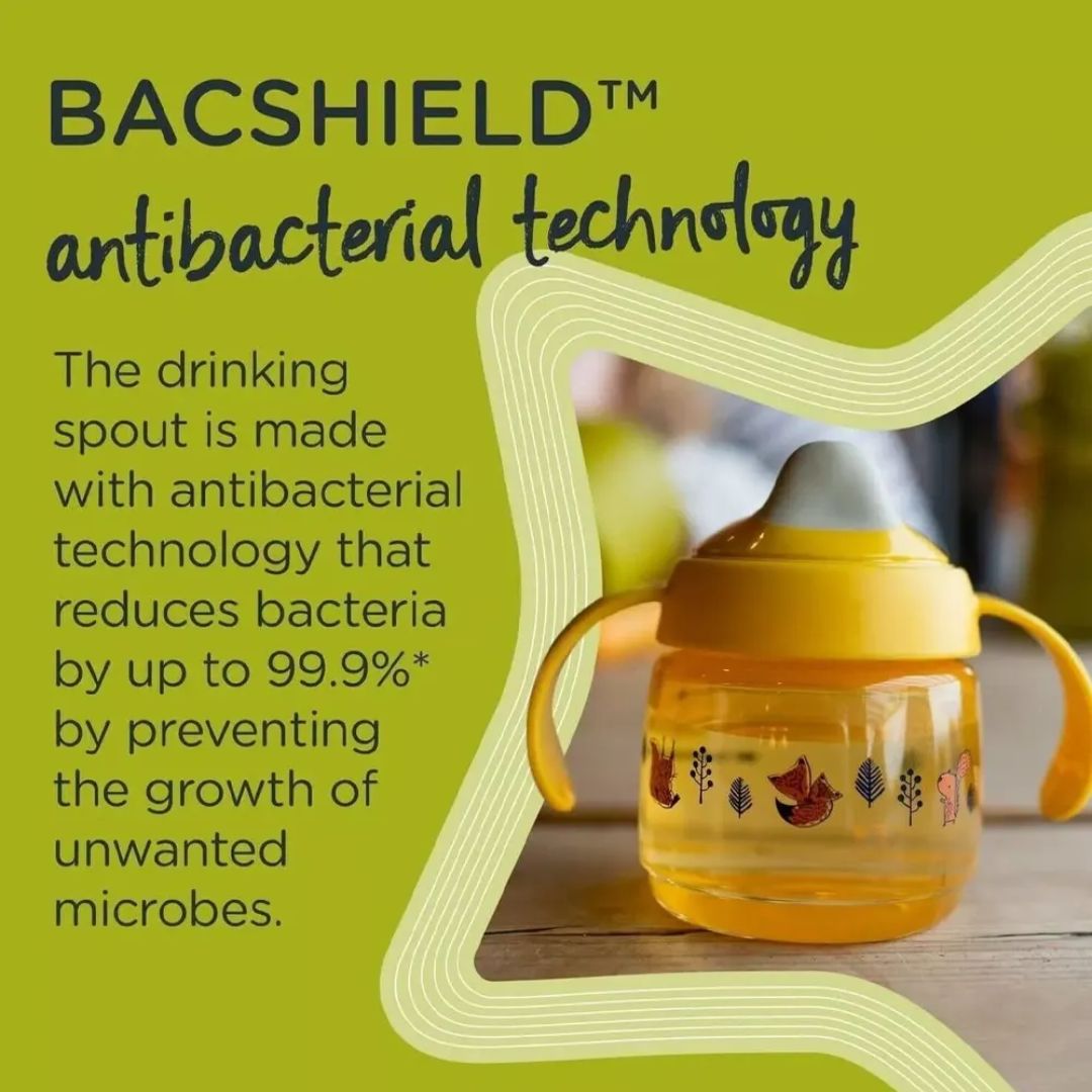 Yellow Tommee tippee sippy cup with antibacterial technology text on a green background
