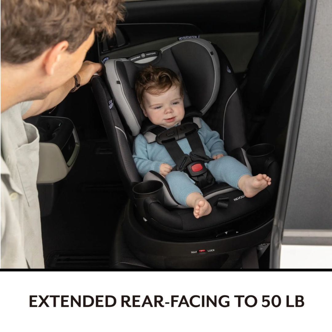 Evenflo Baby in a car seat with an adult beside it, indicating extended rear-facing use up to 50 pounds.