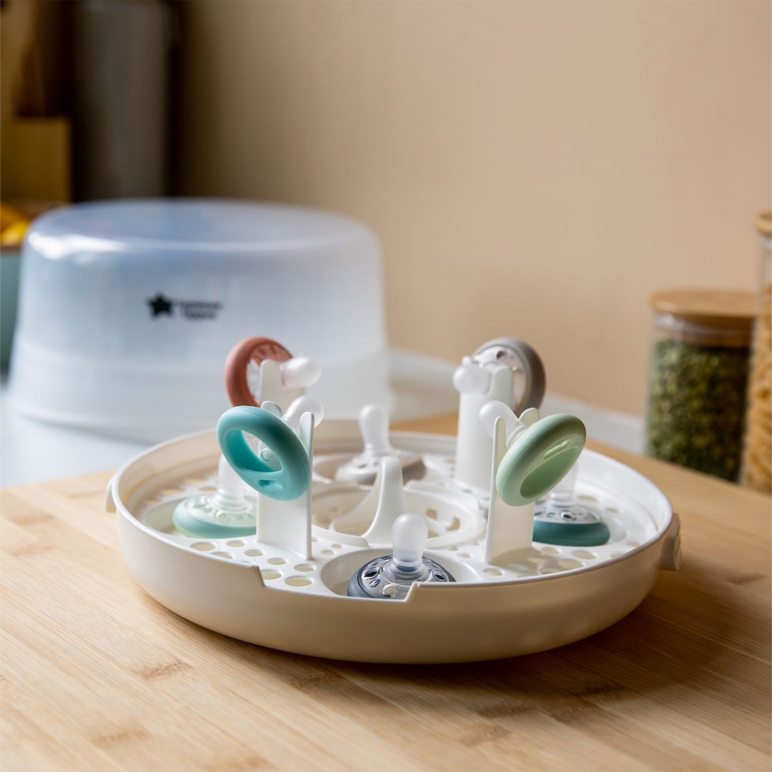 Tommee Tippee Drying rack with baby teething rings on a wooden surface