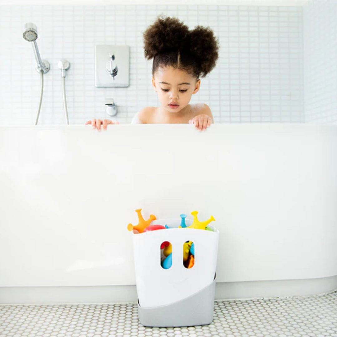 Child playing with colorful toys in a bathtub filled with water