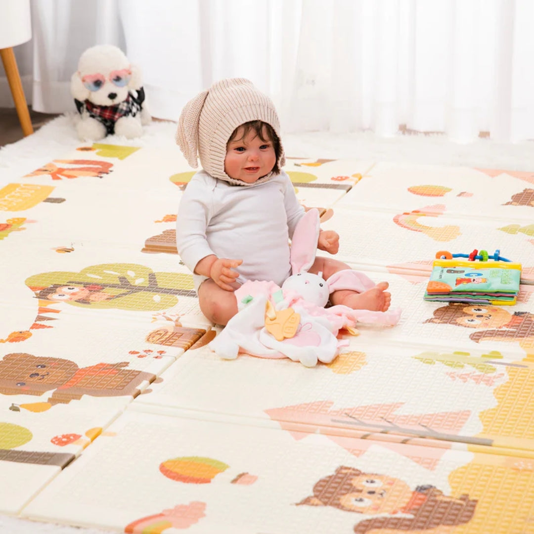 A baby playing on a Miila double sided playmat.