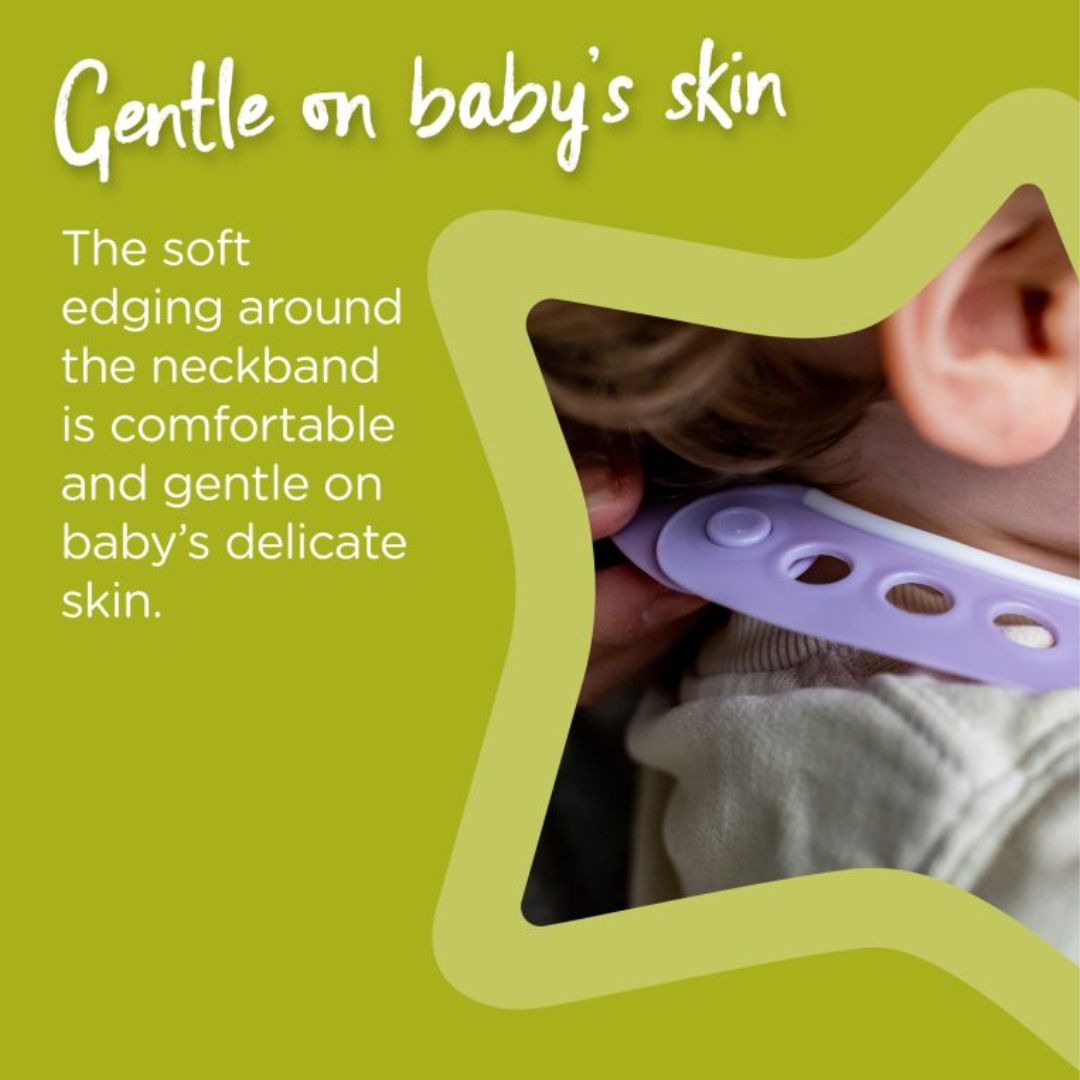 Baby wearing a purple Bib with text about its comfort on baby's skin.
