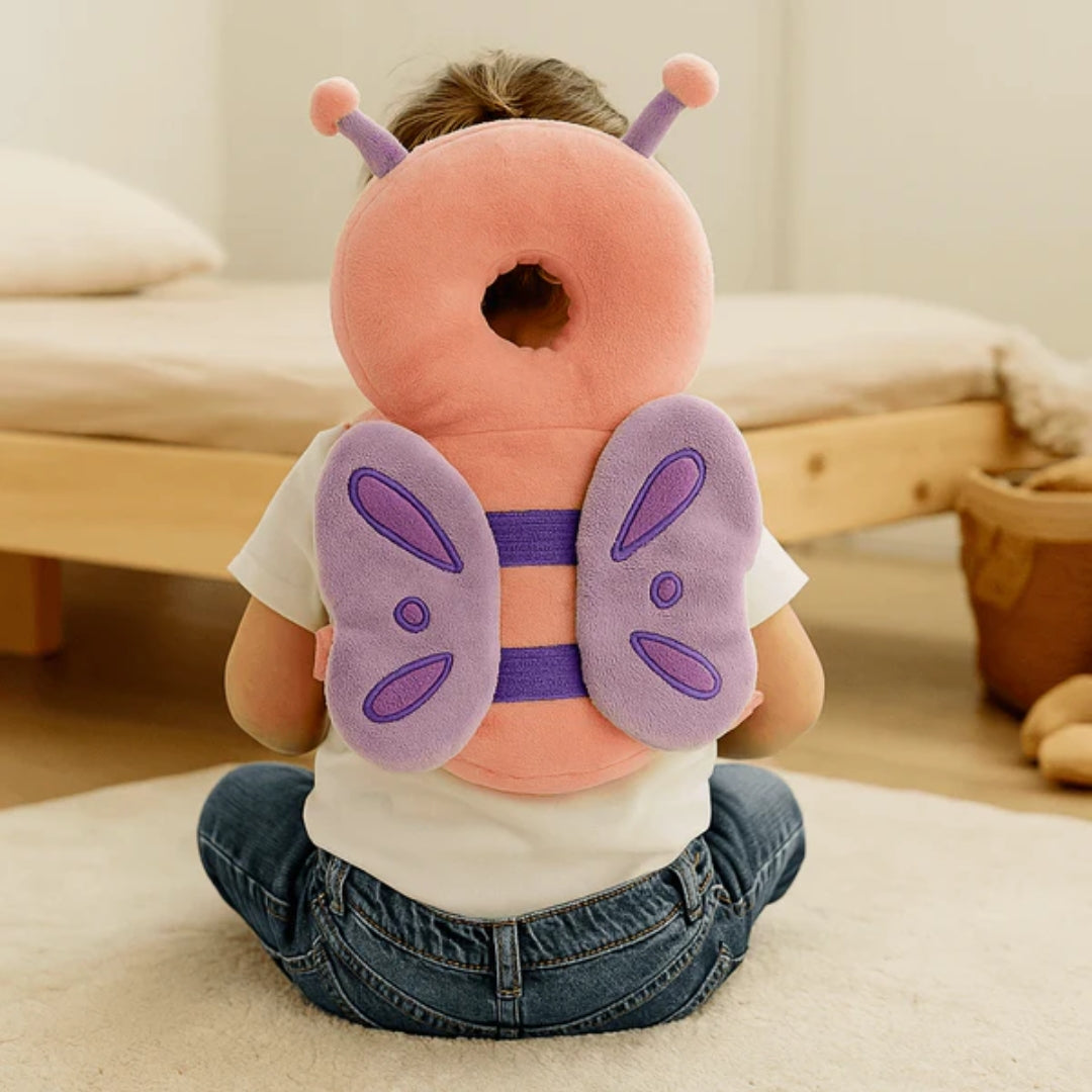 Child wearing a butterfly-shaped headrest pillow in a bedroom setting