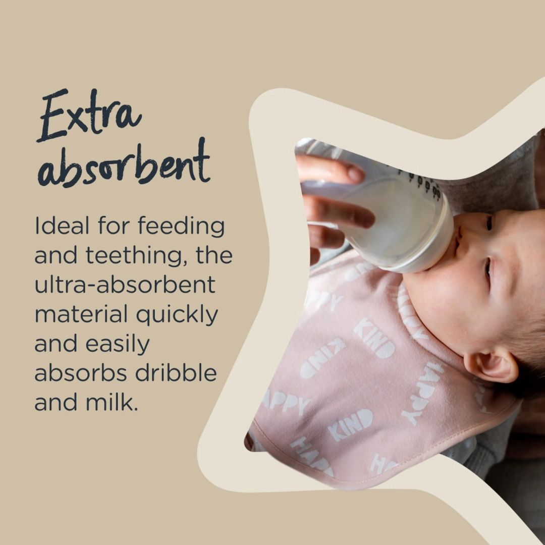 Baby wearing an absorbent Tommee tippee bib while being fed with a bottle, on a beige background.