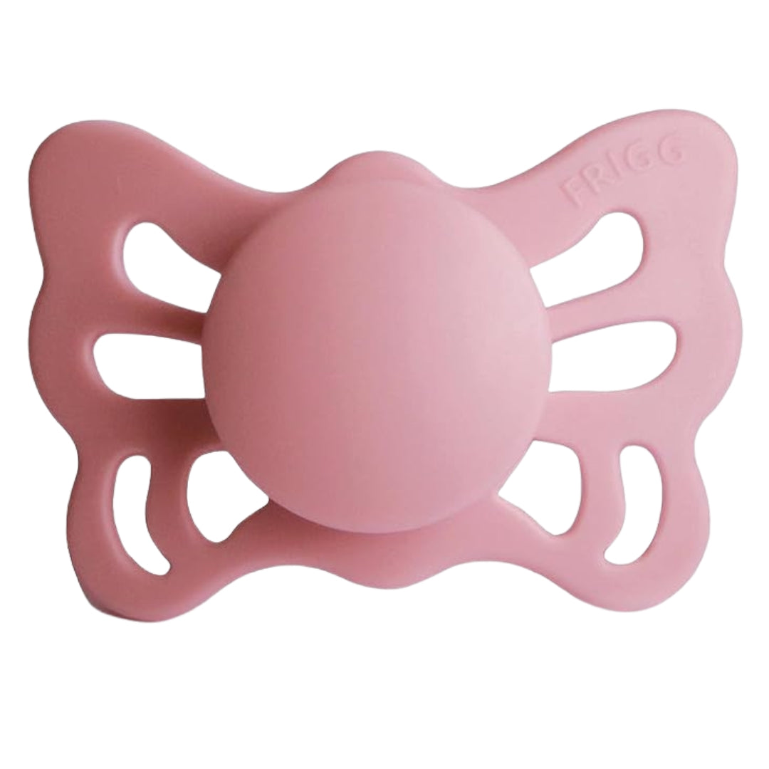 Frigg Pink butterfly-shaped pacifier on a white background