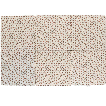 Candide Foldable play mat with a subtle pattern on a white background