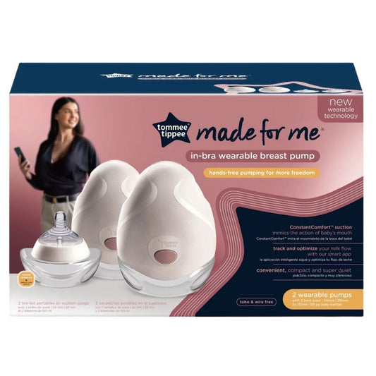 Tommee Tippee in-bra wearable breast pump packaging with a woman using a phone in the background.