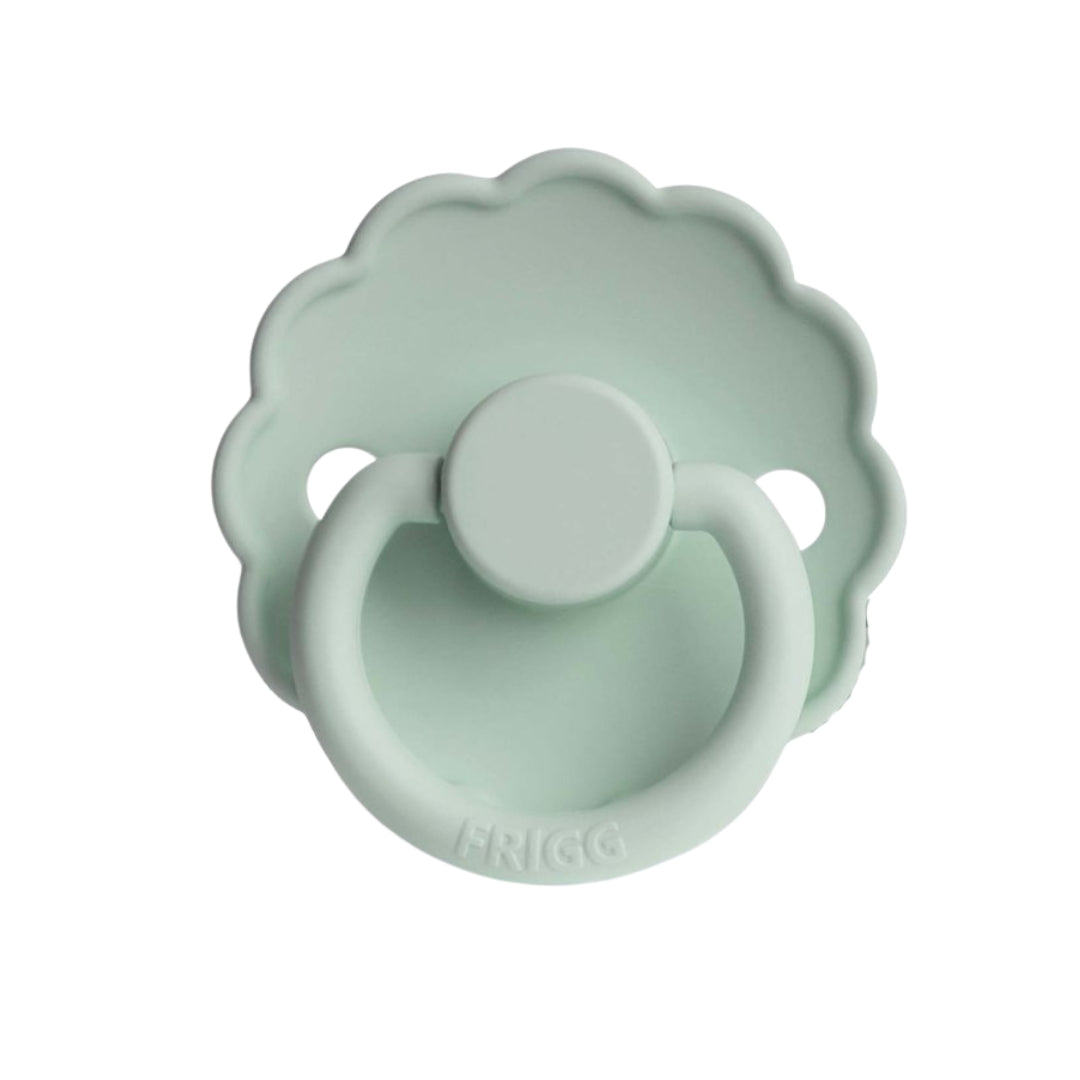 Mint green Frigg pacifier with floral design on a white background