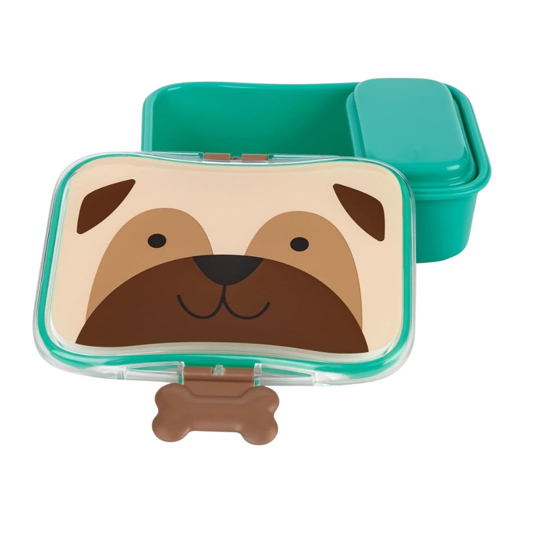 A dog-themed Skip Hop lunch box with a clear lid featuring a cartoon dog face, shown with a bone-shaped clasp and a teal inner container behind it on a white background.