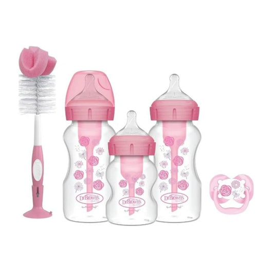 Dr. Brown's Baby bottle set with pink caps and pacifier on a white background