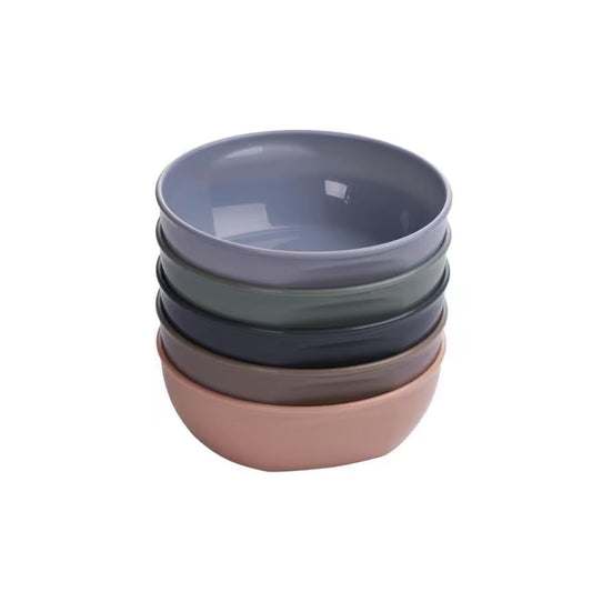 Stack of five Vital Baby bowls in different colors on a white background