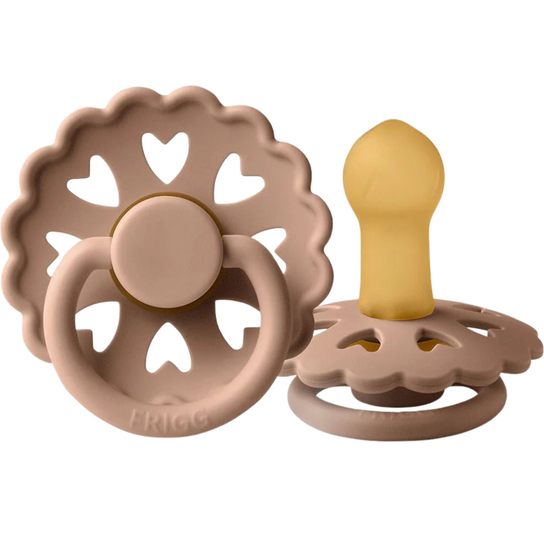 Frigg baby teething toys with heart designs on a white background