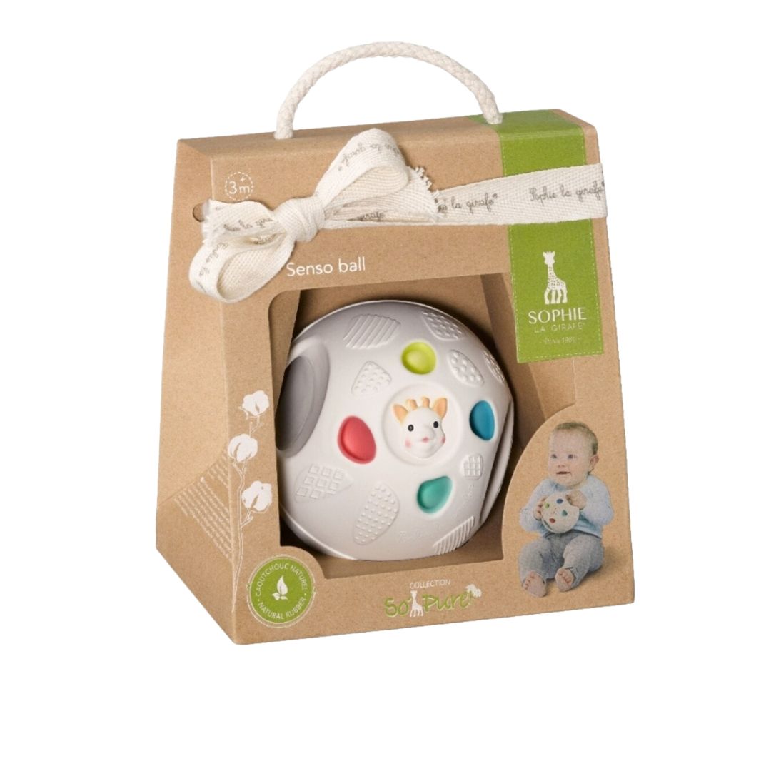 Sophie la Girafe Senso Ball in retail packaging, a white textured sensory ball with colorful accents in green, red, blue, and teal, labeled 3 months and up, made from natural rubber.