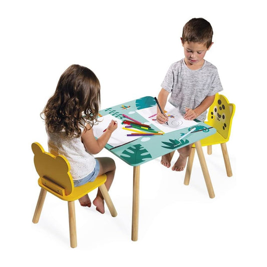 Janod Two children sitting at a colorful children's table with chairs, drawing on paper.