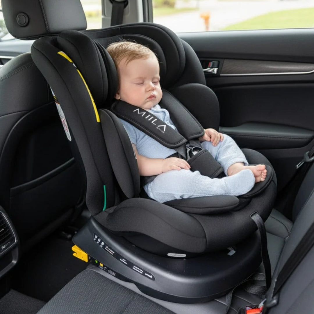 Baby in a car seat with Miila branding inside a vehicle.