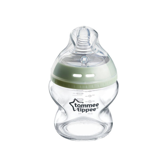 Clear baby bottle with green cap on a white background, featuring Tommee Tippee logo.
