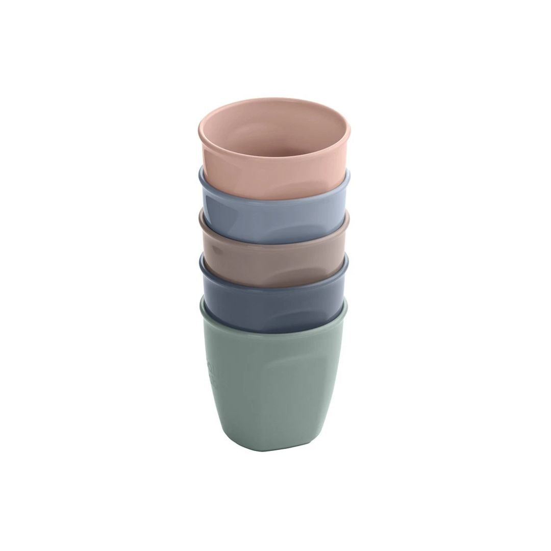 Stack of colorful ceramic vital baby  cups on a white background