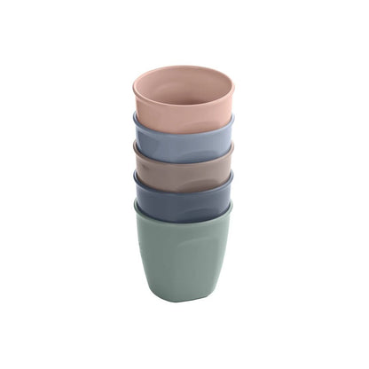 Stack of colorful ceramic vital baby  cups on a white background