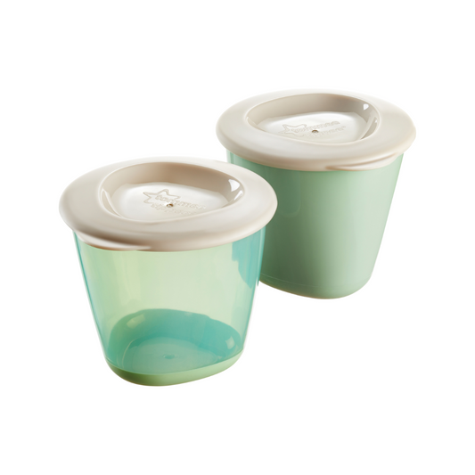 Two green Tommee tippee Pots with beige lids on a white background