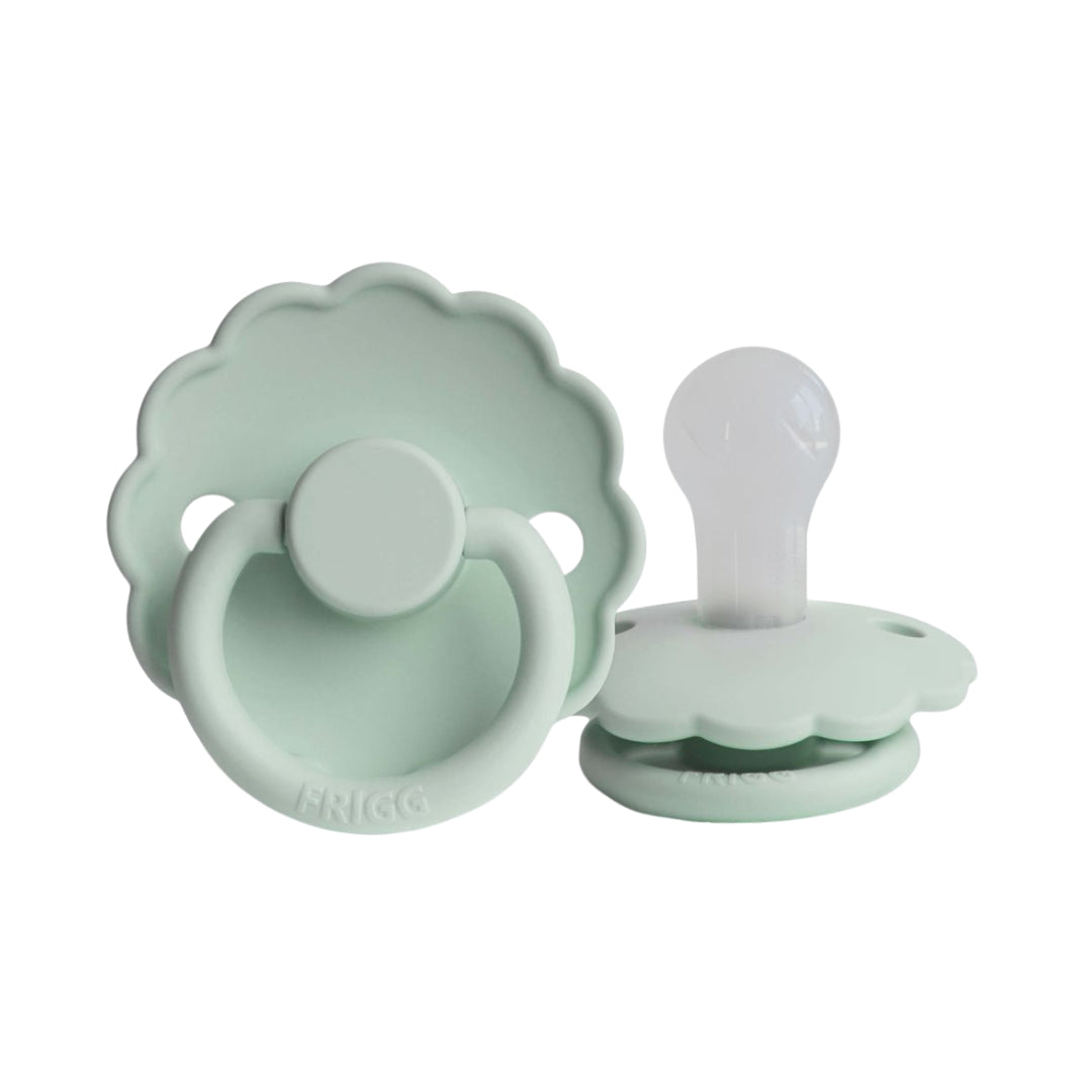 Frigg light green pacifiers on a white background