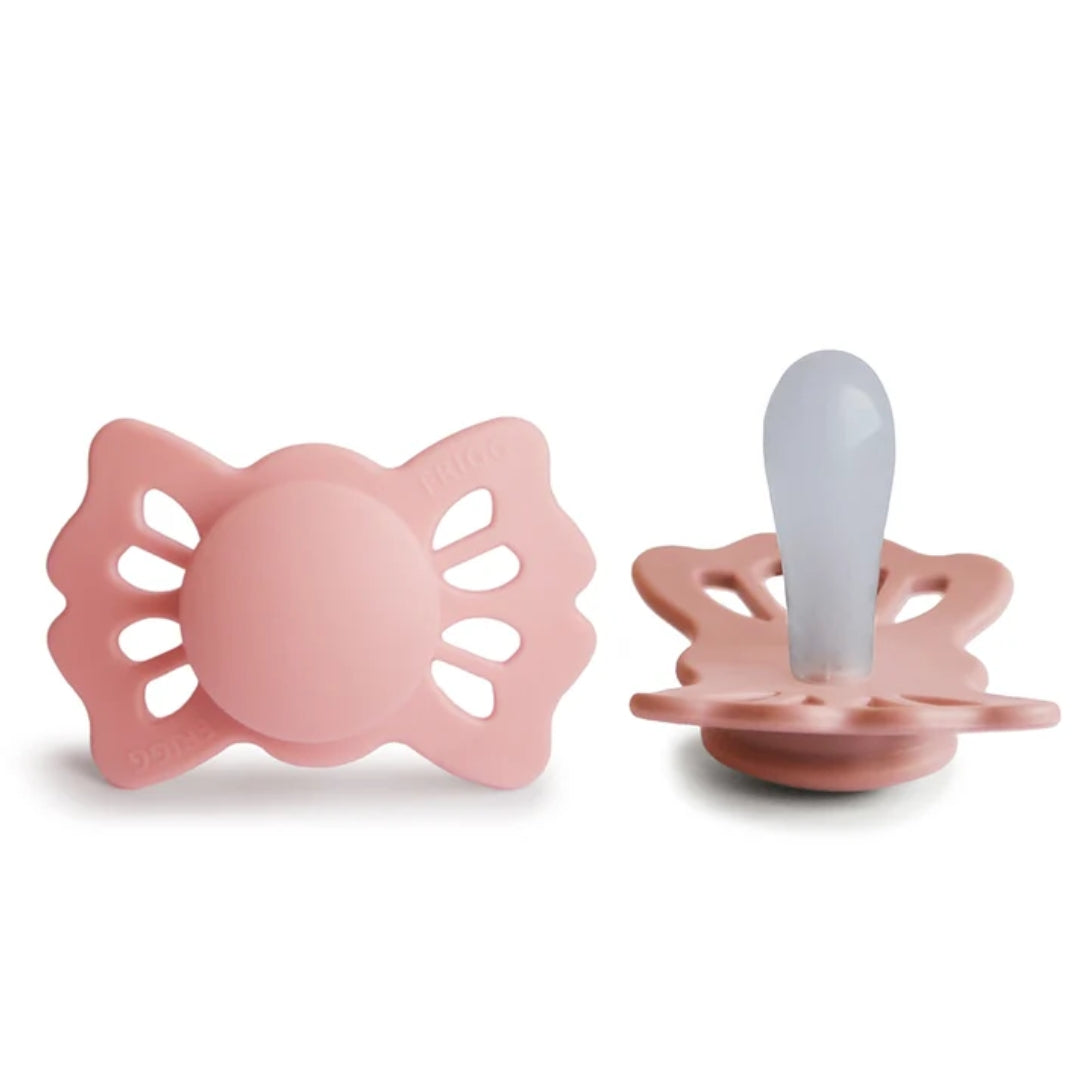 Frigg pink baby pacifiers on a white background