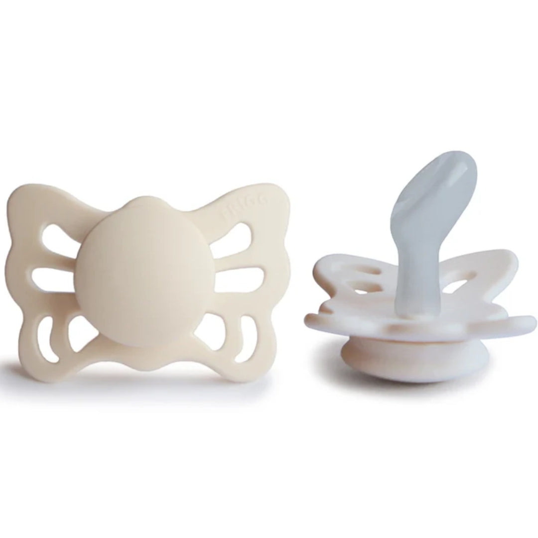 Frigg Beige butterfly-shaped pacifiers on a white background