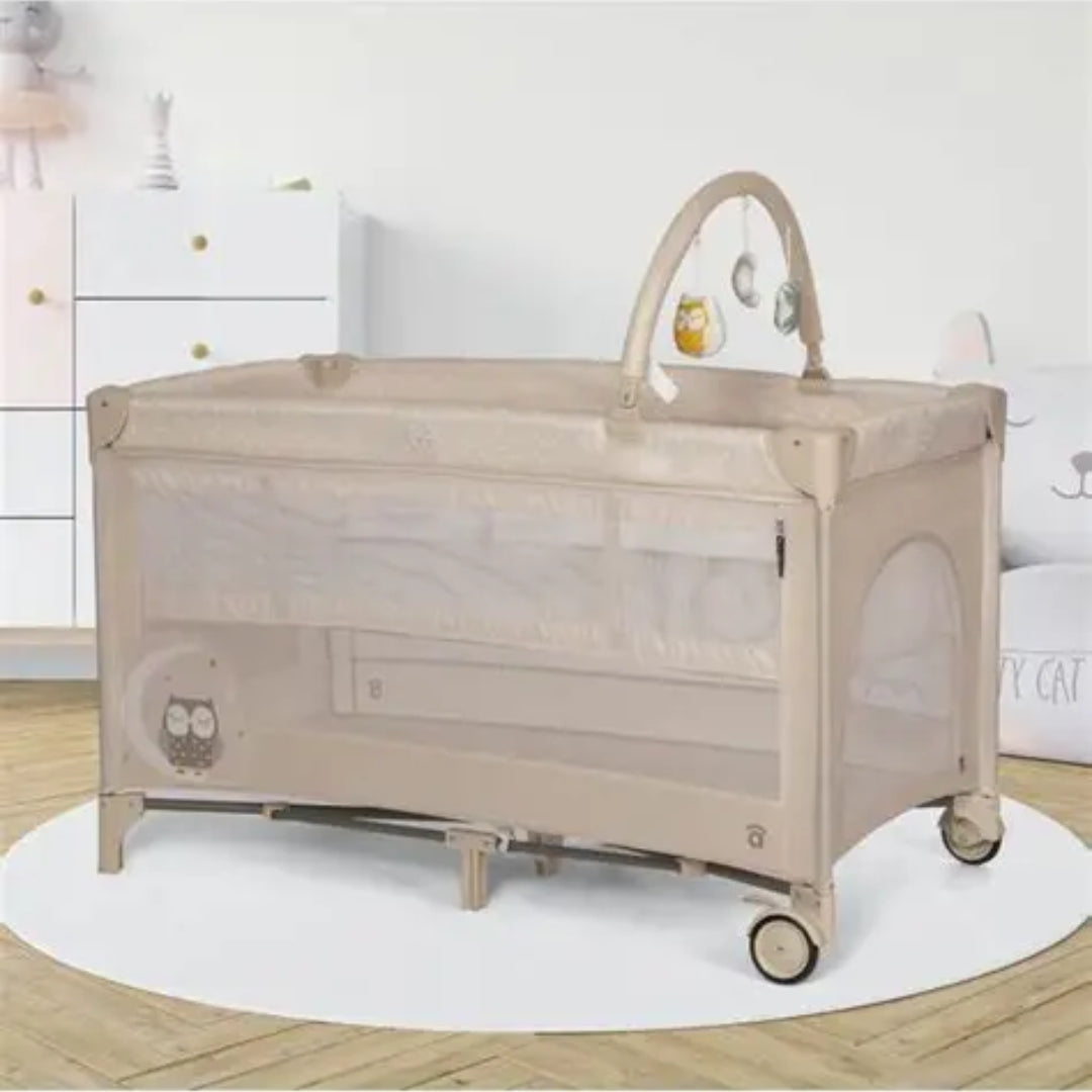 Asalvo Beige baby crib with wheels on a white rug in a room setting