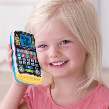 Child holding a Vtech toy phone with colorful buttons and a screen.