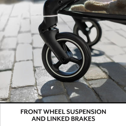 Close-up of an Evenflo stroller wheel with front wheel suspension and linked brakes on a paved surface.