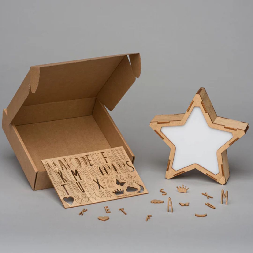 Wooden lettering set with a star-shaped wooden lamp on a gray background