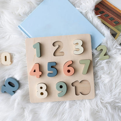 Pearhead Wooden number puzzle on a fluffy white surface