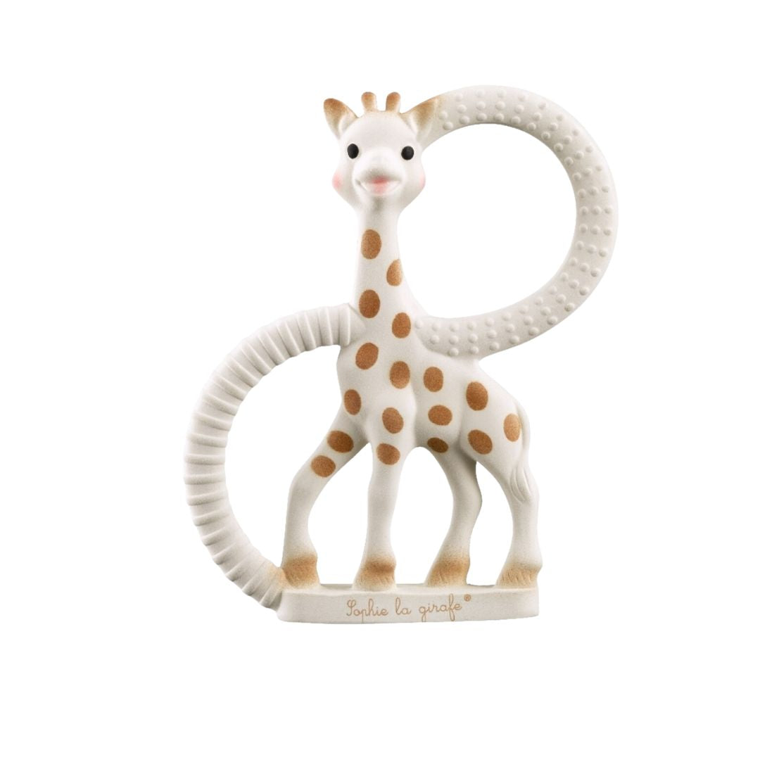 Sophie la Girafe teething ring, a natural rubber teether shaped like the spotted giraffe with a textured looped tail forming the ring, shown on a white background.