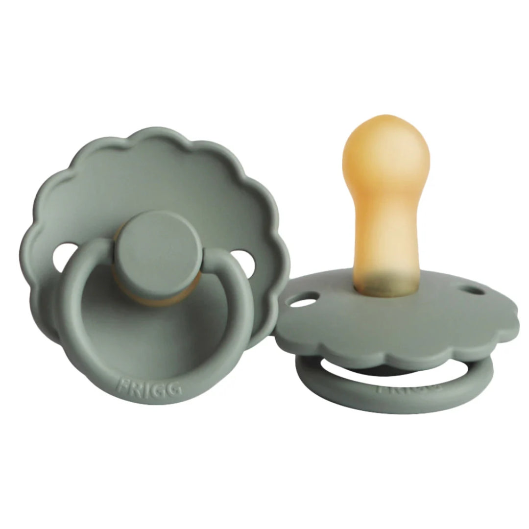Frigg green pacifiers with Silicone nipples on a white background