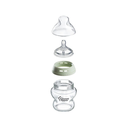 Baby bottle parts including a nipple, teat, and bottle body on a white background