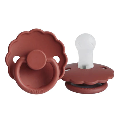 Frigg Brown baby pacifiers on a white background
