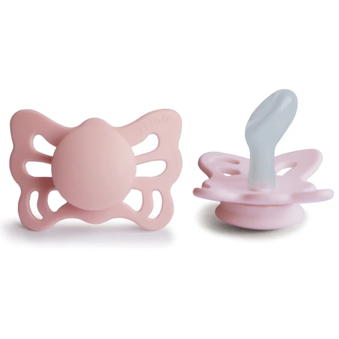 Frigg Pink butterfly-shaped pacifiers on a white background.