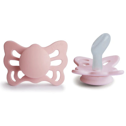 Frigg Pink butterfly-shaped pacifiers on a white background.