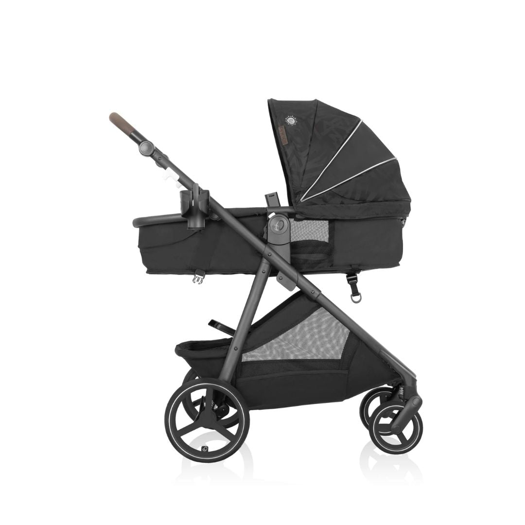 Black evenflo baby stroller with folded bassinet on a white background